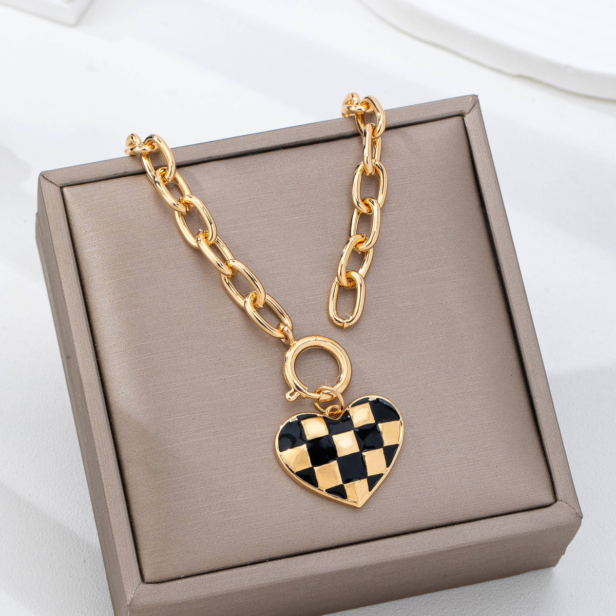 Gold toggle necklace with black and gold checkered heart