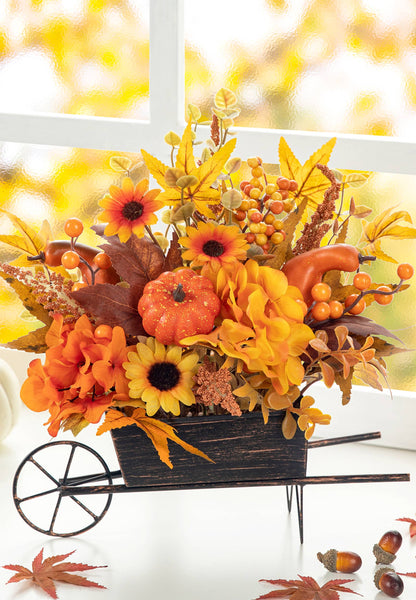 Small metal wheel barrow full of fall flowers & foliage