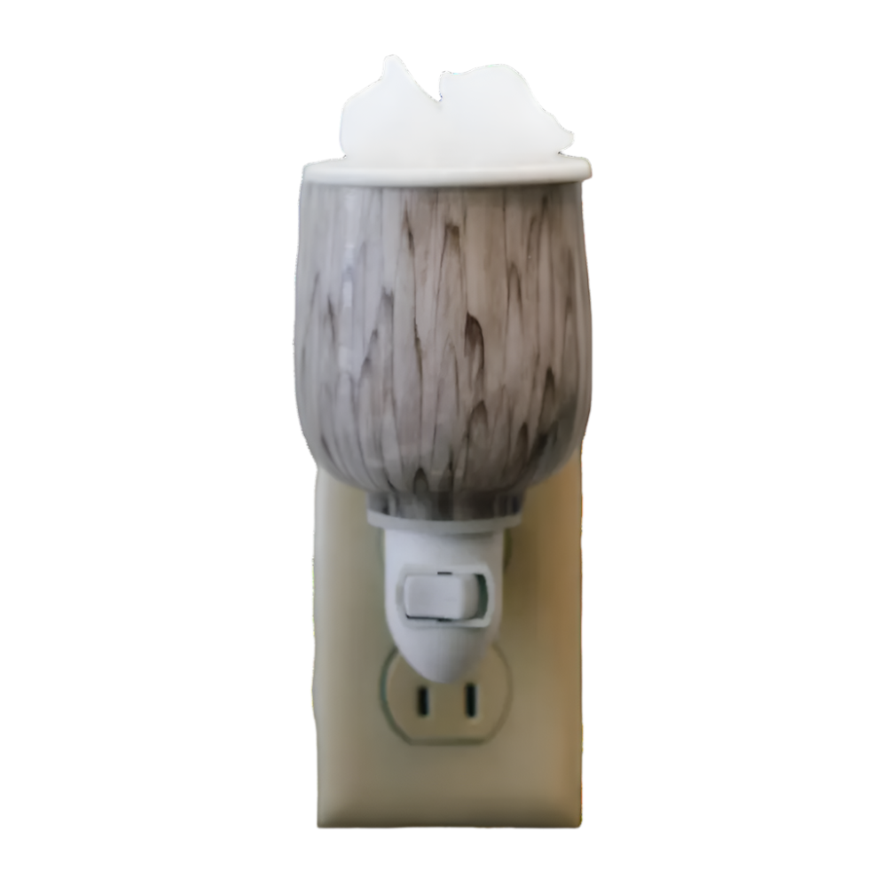 beige and white marble wax warmer plugged into outlet