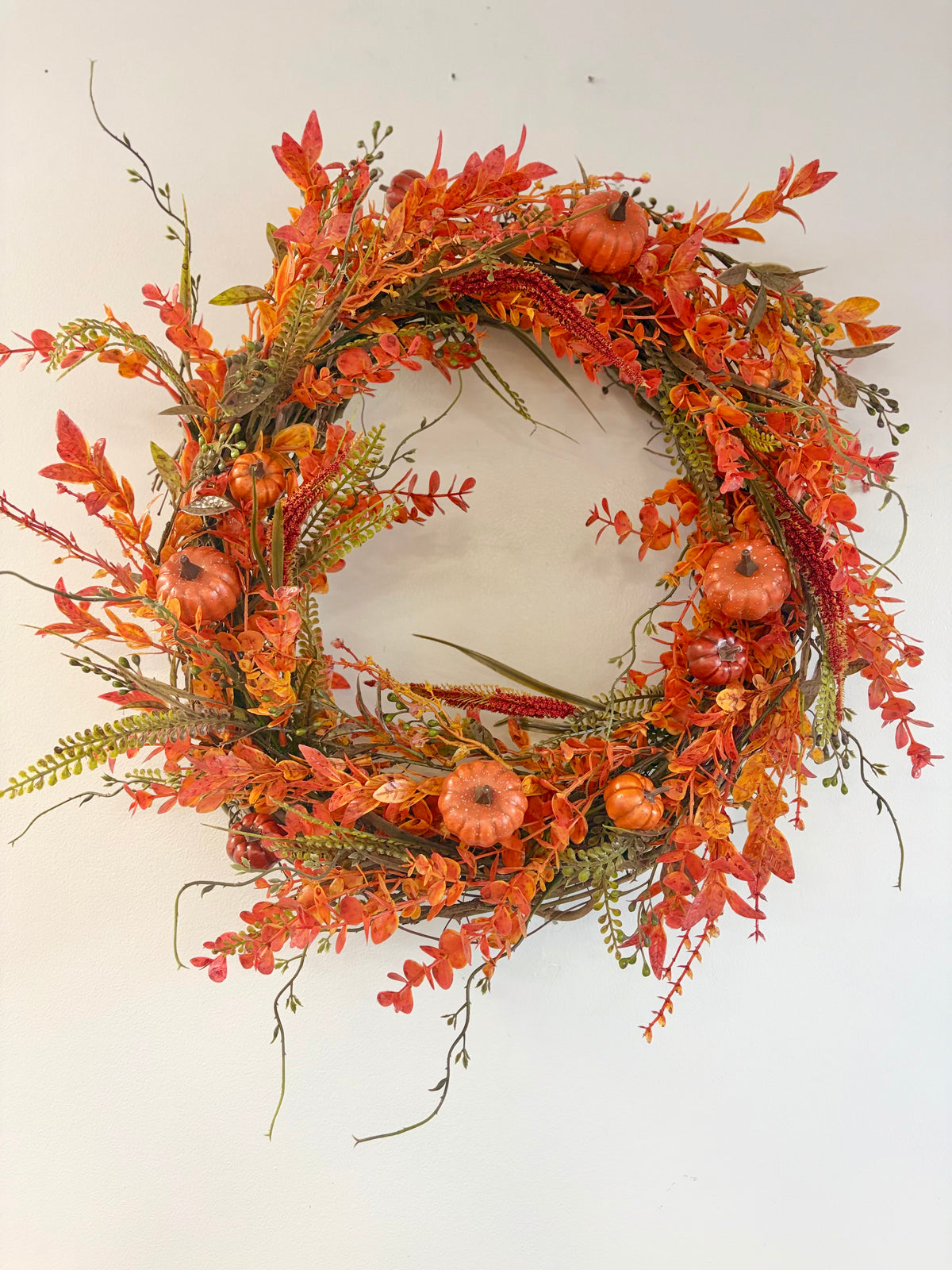 18" round wreath with orange fall foliage and orange pumpkins
