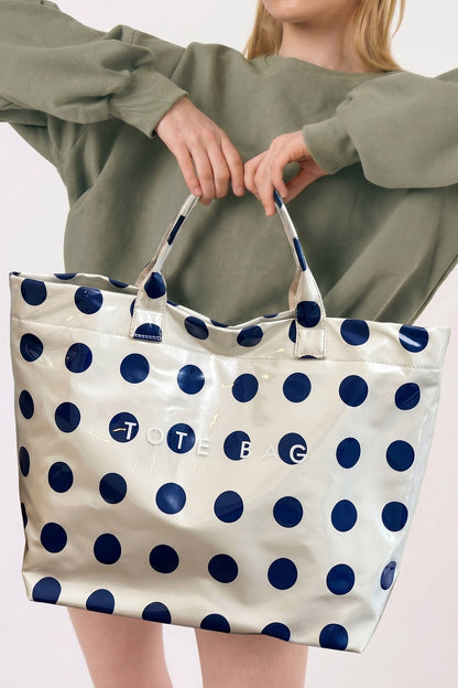 Glossy Waterproof gray tote bag with blue polka dots with the word "tote bag" across the front