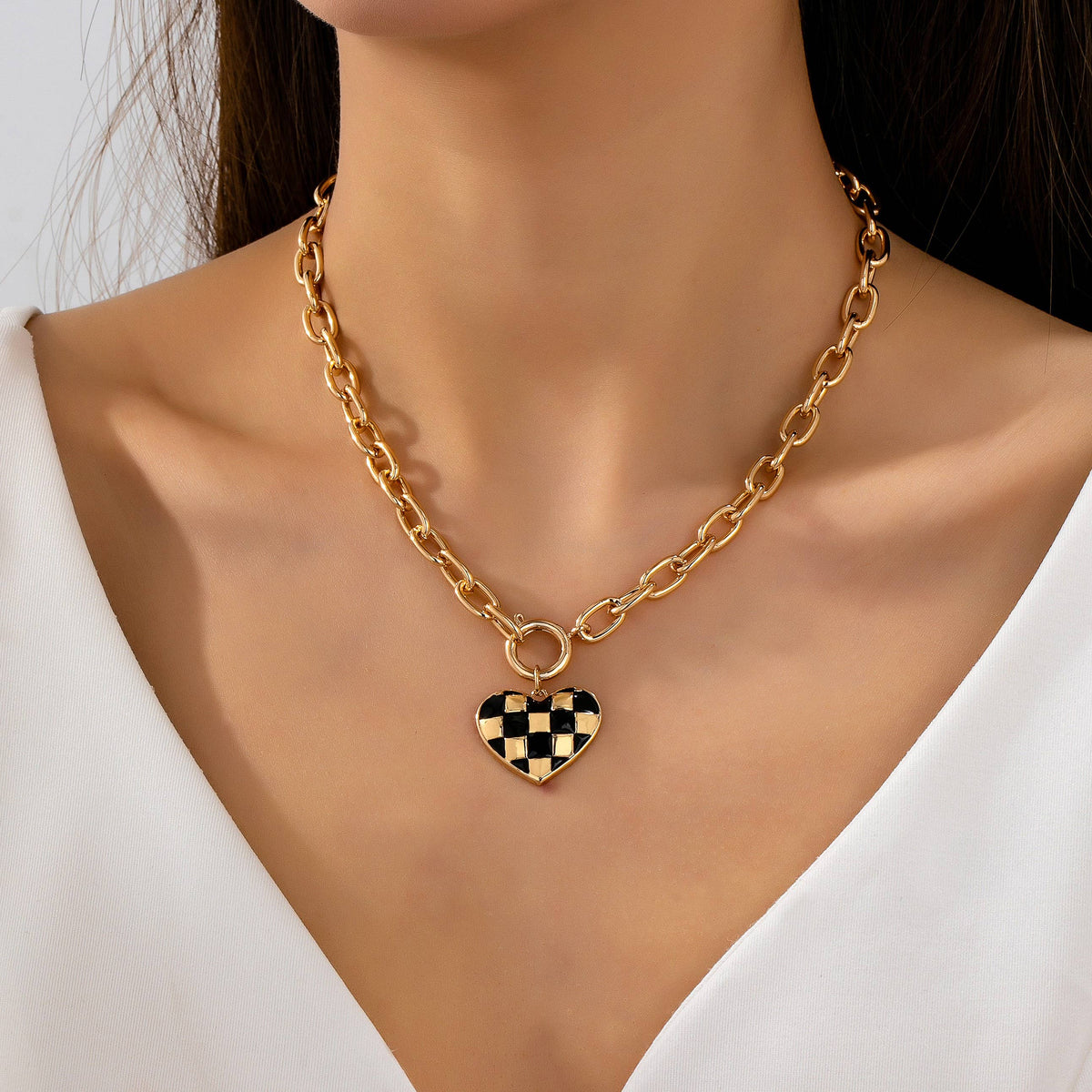 Gold toggle necklace with black and gold checkered heart