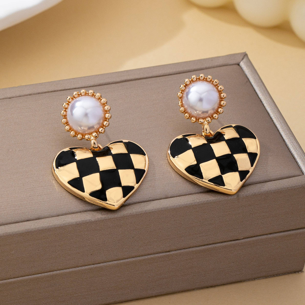 vintage styled black and gold checkered heart drop earrings with faux pearl.