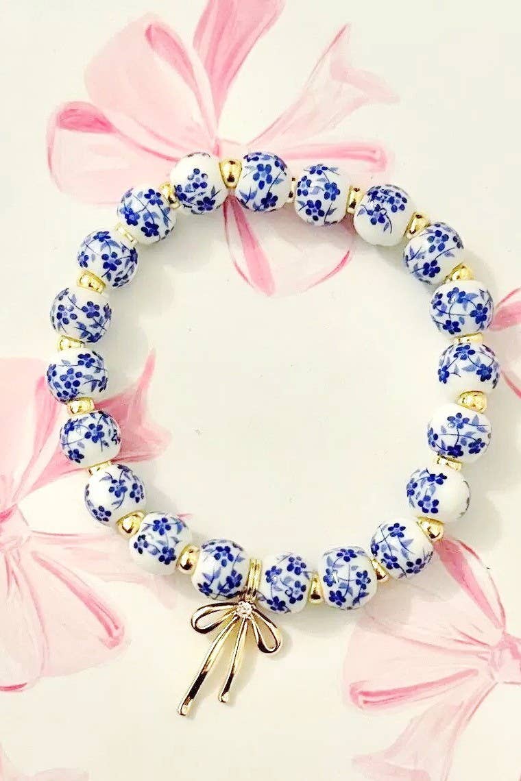 blue and white toile beaded bracelet with gold bow charm