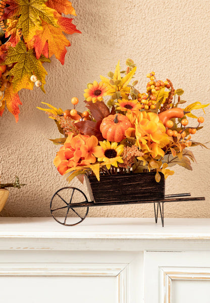 Small metal wheel barrow full of fall flowers & foliage