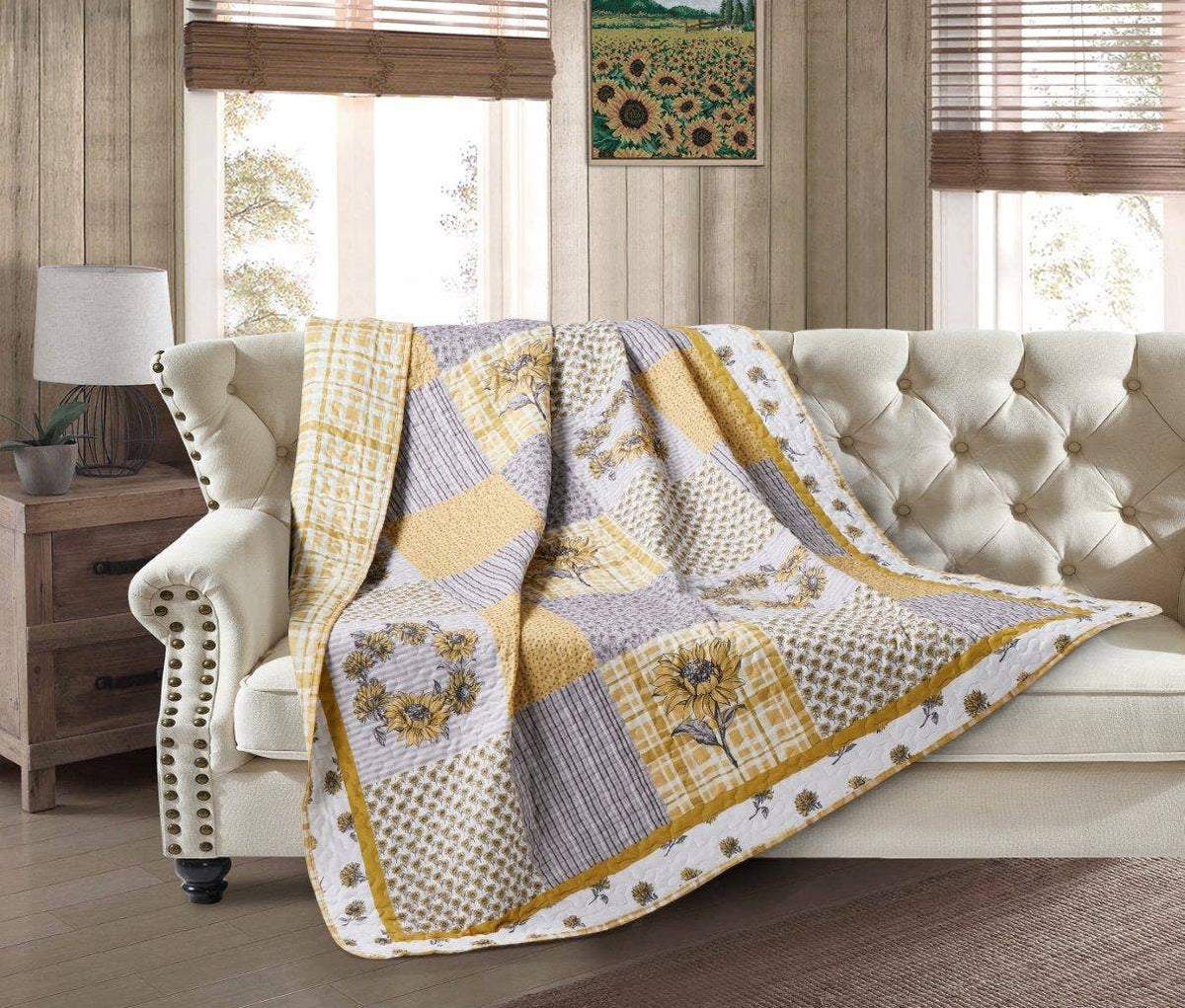 patchwork quilt with gray squares and yellow sunflowers
