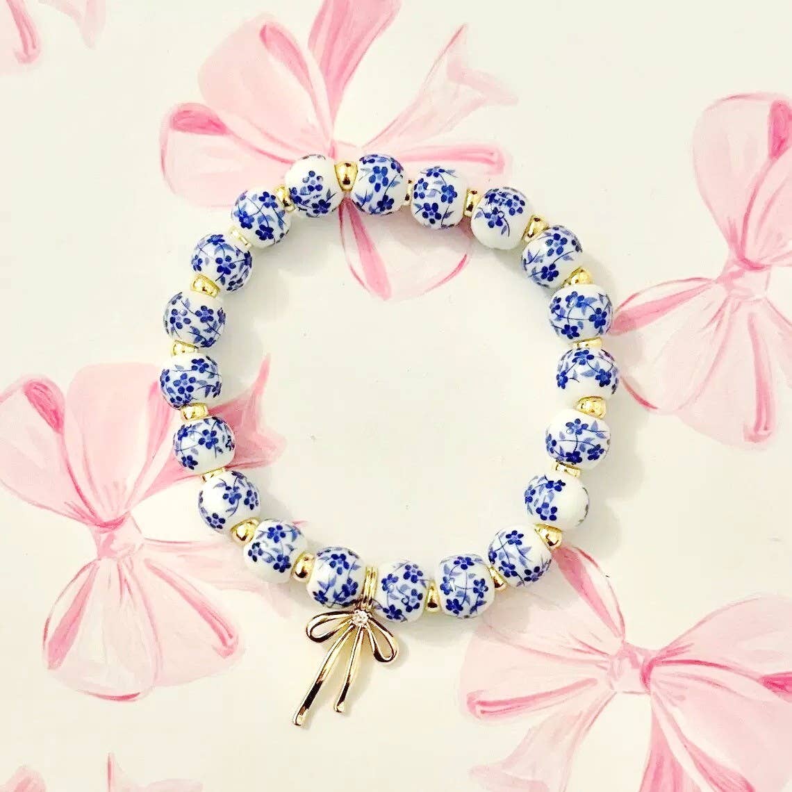 blue and white toile beaded bracelet with gold bow charm